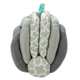 An Adjustable Breast Feeding Pillow by Mother and Baby with a bow on it.