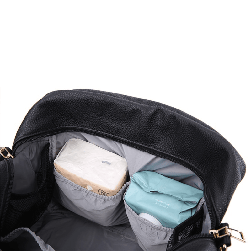 A Lily - Black diaper bag filled with diapers and wipes from Mother and Baby.