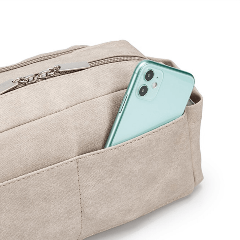 A mint green smartphone with three cameras protruding from a Mother and Baby Pram Caddy featuring universal stroller straps on a white background.