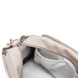 Light beige canvas Pram Caddy with an adjustable shoulder strap and an open zipper revealing a gray interior, placed on a white background.