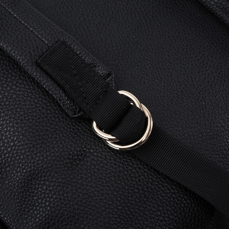 A close up of a Lily - Black leather backpack with a gold buckle by Mother and Baby.