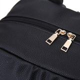 A close up of a Lily - Black leather backpack with gold hardware by Mother and Baby.