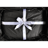 A black M&B Gift Box Experience with a white ribbon tied around it.