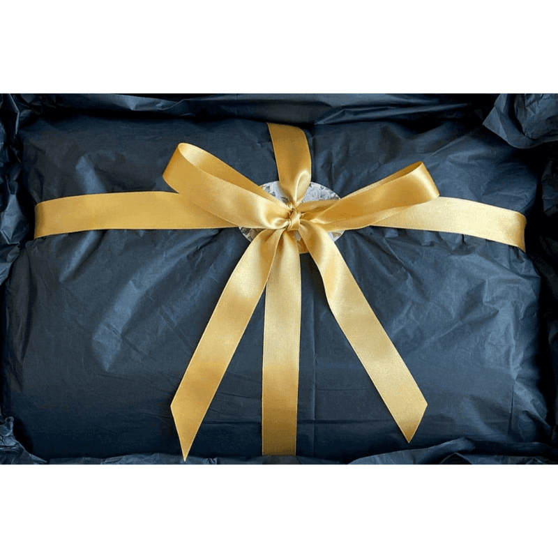 An M&B Gift Box Experience with a gold ribbon tied around it.