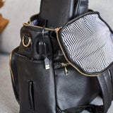 A Ava - Black leather diaper bag with a zippered compartment made by Mother and Baby.