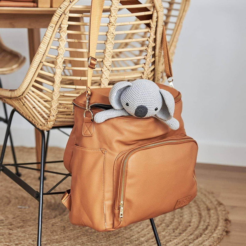An Ava - Caramel backpack with a koala in it, made by Mother and Baby.