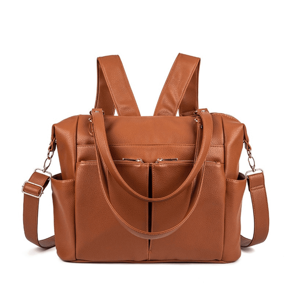 An Ivy - Caramel leather diaper bag with two straps and a shoulder strap by Mother and Baby.