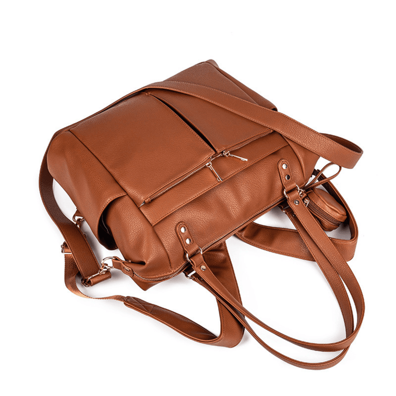 An Ivy - Caramel leather bag with two straps and a shoulder strap by Mother and Baby.