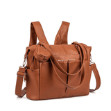 A Ivy - Caramel leather diaper bag with a shoulder strap by Mother and Baby.