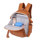 An Olivia - Caramel backpack with an open compartment. (Brand: Mother and Baby)