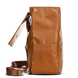 A Scarlett - Caramel leather backpack with a strap, from Mother and Baby brand.