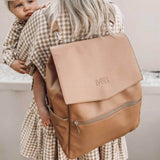 A woman holding a baby in a Mother and Baby Scarlett - Latte backpack.