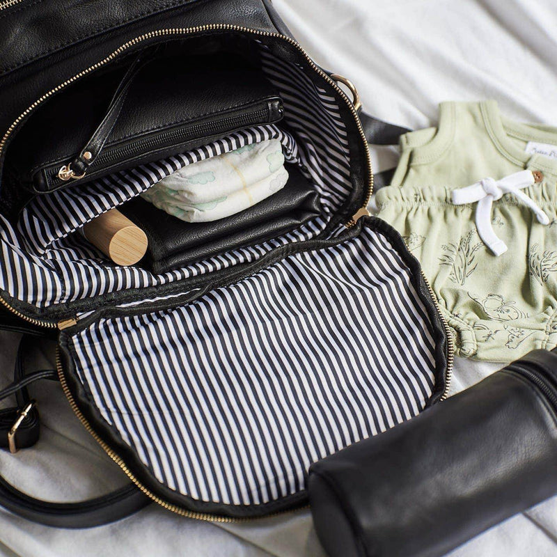A Sophia - Black diaper bag with a baby's belongings inside, by Mother and Baby.