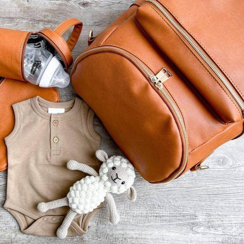 A Sophia - Caramel diaper bag with a teddy bear and a bottle made by Mother and Baby.