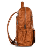 A Willow - Tan backpack by Mother and Baby on a white background.