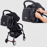 A Mother and Baby Pram Organiser, a black stroller with a bag attached to it.