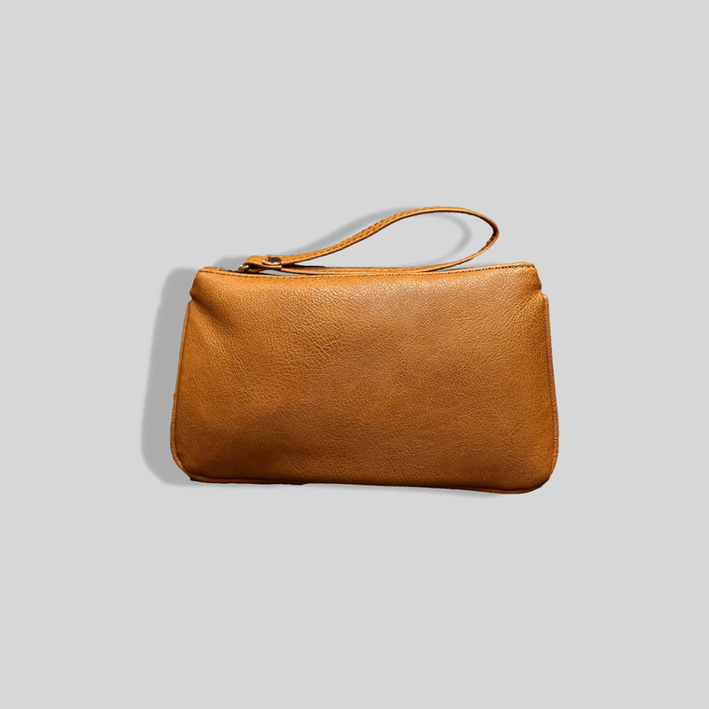 A Zip Purse - Caramel by Mother and Baby on a grey background.