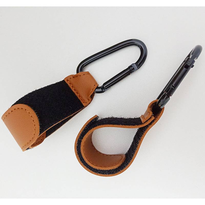 A pair of Luxe Stroller Strap carabiners by Mother and Baby on a white surface.